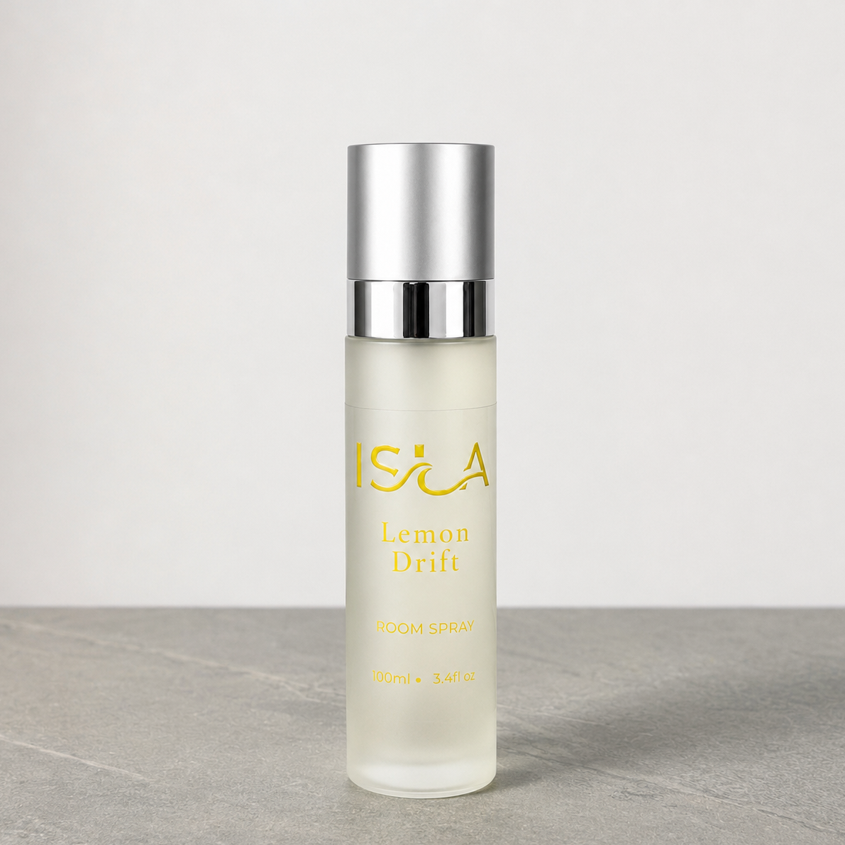 isla lemon drift room spray bottle on stone surface with white background