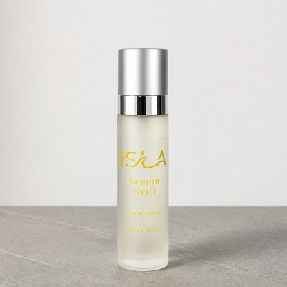 isla lemon drift room spray bottle on stone surface with white background