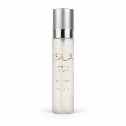 Room spray bottle labeled 'isla' Warm Sand' on a white background